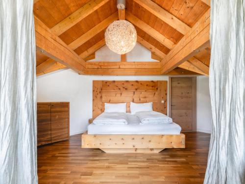 a bedroom with a bed with a wooden ceiling at Chalet Sendlhofer in Bad Hofgastein
