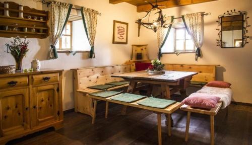 a kitchen with a table and a bench and a table at Ferienhaus Staller Brendl in Sankt Georgen in Obdachegg