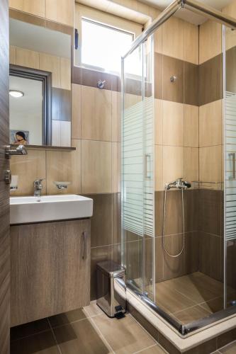 a bathroom with a shower and a sink at Villa Thea in Triopetra