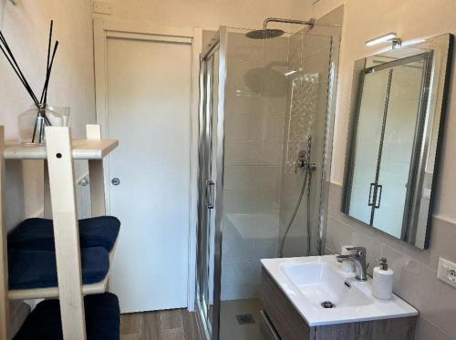 a bathroom with a sink and a shower with a mirror at Casa del Sole in Versilia in Cinquale