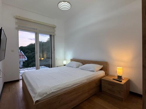 a bedroom with a bed and a large window at Przno in Pržno