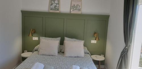 a bedroom with a bed with two white pillows at Tía Pepa in El Gastor