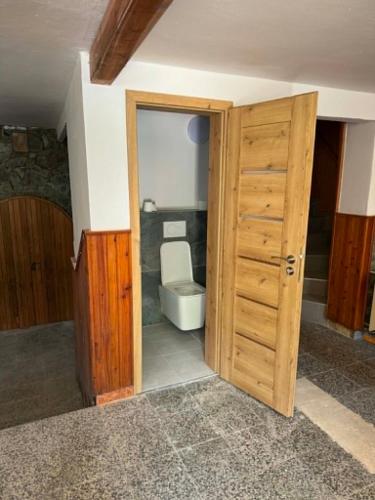 an open door to a bathroom with a toilet at Apartment sklep 33E in Hrušky