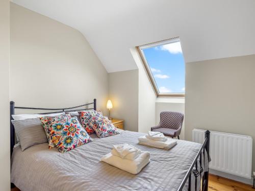 a bedroom with a bed with two towels on it at Connemara Bay House in Moyard