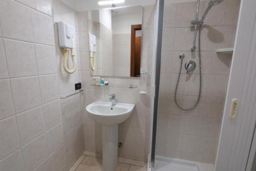 a bathroom with a sink and a shower at Hotel Nuovo Metrò in Milan