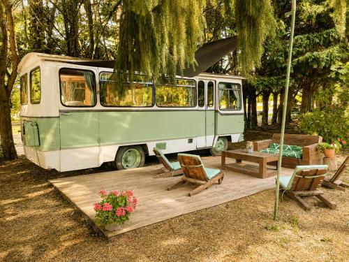 a green and white van parked under a tree at Tiny house - Bus insolite - avec Escape Game in Mignaloux-Beauvoir
