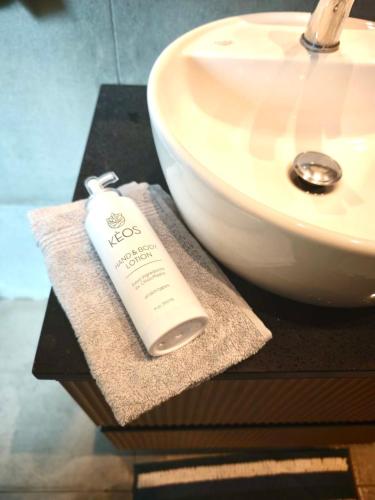 a bottle of soap sitting on a table next to a sink at Casa del Quadro in Chios