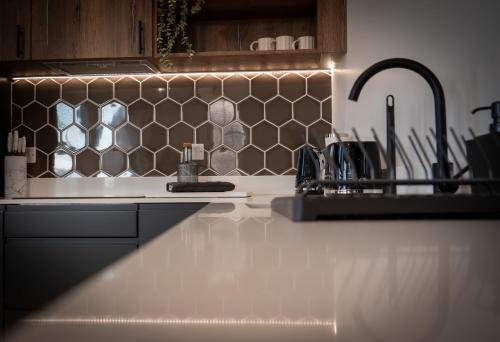 a kitchen with a sink and a counter top at Dwell Living North Bridge Apartments in Sunderland