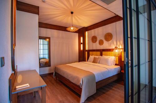a bedroom with a bed and a table and a mirror at Hayal Vadisi Suite Hotel in Trabzon