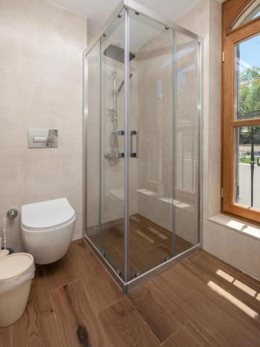 a bathroom with a shower and a toilet at The Mint Urla in Kuscular