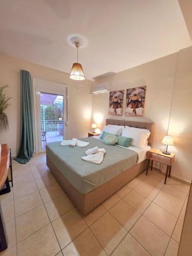 a bedroom with a large bed with two towels on it at Mylo Casa Karfas in Chios