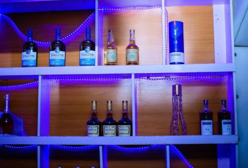 a shelf with bottles of wine on it at Rotana Hotel and Suits in Ilorin