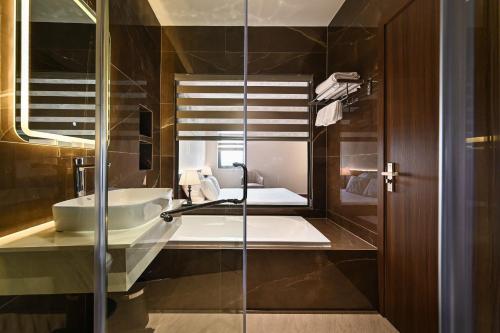 a bathroom with a sink and a mirror at Khách sạn Neva in Long An