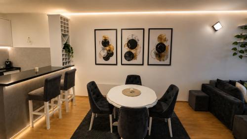 a living room with a white table and black chairs at Urban Center Paraćin in Paraćin