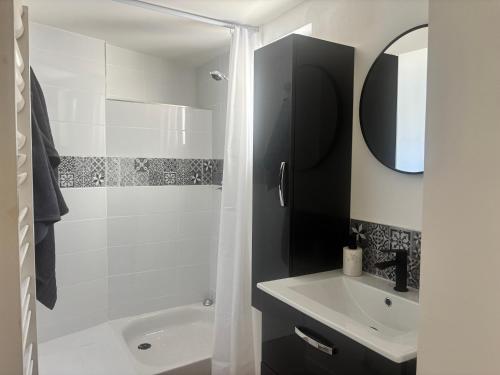 a white bathroom with a shower and a sink at Petite halte à Volnay in Volnay
