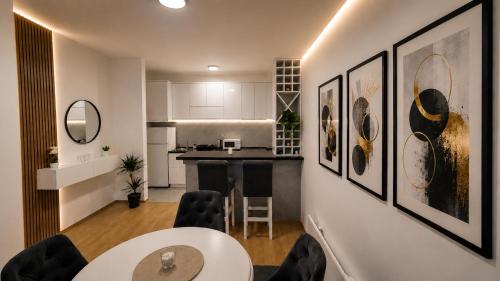 a kitchen and living room with a table and chairs at Urban Center Paraćin in Paraćin