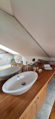a bathroom with a white sink on a wooden counter at Roby53 in Parabiago