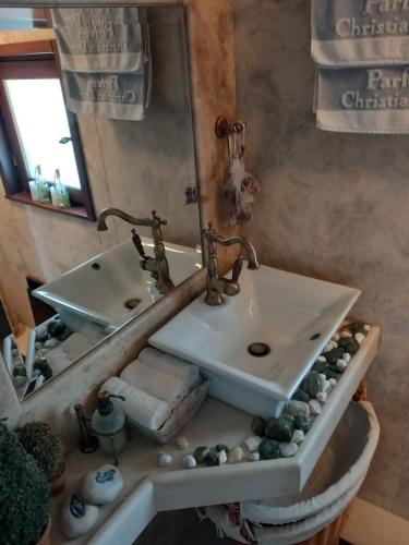a bathroom with a sink and a mirror at Elis superb house in Psathíon
