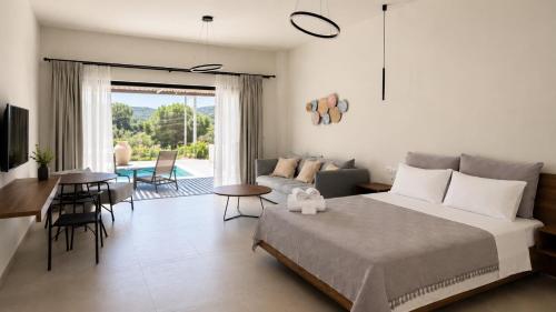 a bedroom with a bed and a living room at Nόka Suite Apartments in Faliraki