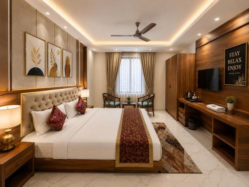 a bedroom with a large bed and a television at The Comfort Villa Manage By Bellamount Hotel Free Airport Pick Up & Drop in New Delhi