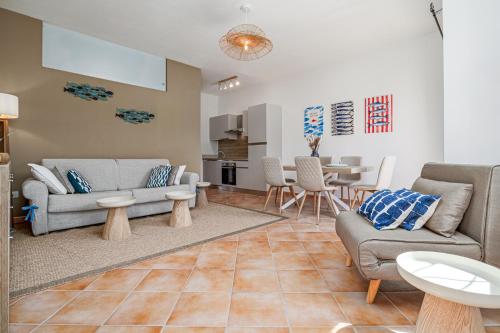 a living room with two couches and a table at Agio Porto Cervo in Liscia di Vacca