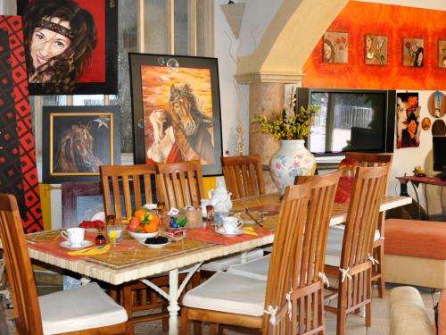 a dining room with a table and chairs at Casa d' Artista B&B in Ozieri