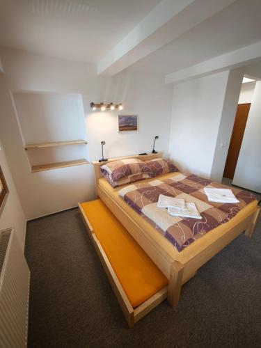 a bedroom with a large bed in a room at Riegrova Chata Kozákov in Semily