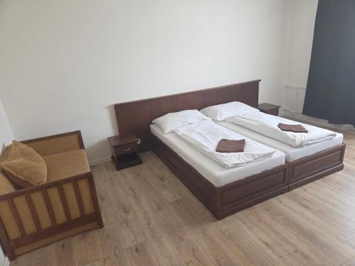 a bedroom with two beds and a wooden floor at Laguna ubytovanie 2 A in Trenčín
