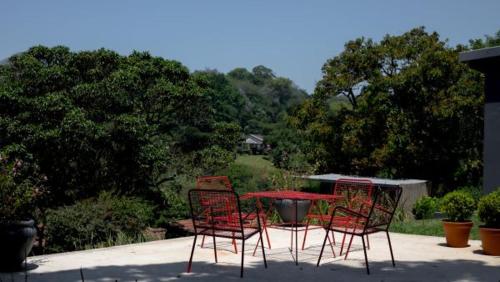 a group of chairs and a table in a patio at Satoris in Kloof