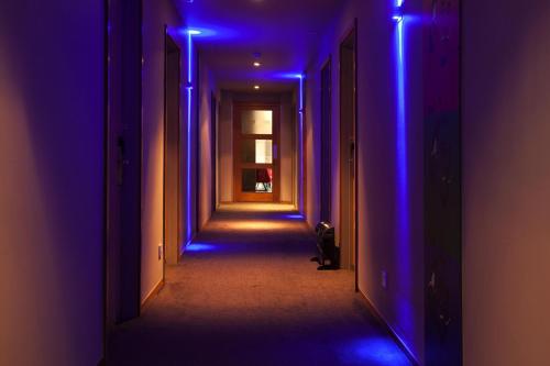 an empty corridor with blue lights in a hallway at Best Western Atlantic Hotel in Chelmsford