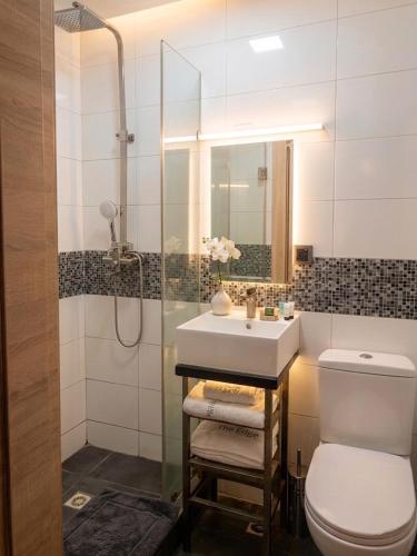 a bathroom with a sink and a toilet at Edge ONE Resort in Gwarinpa