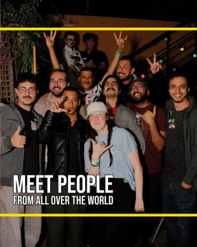a group of men posing for a picture with the words meet people from all over at Garoa Hostel Party Bar in São Paulo