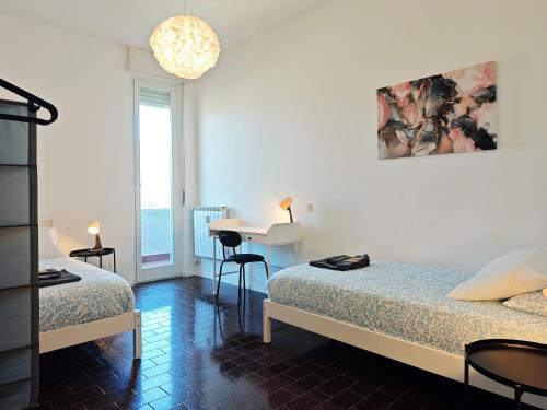 a bedroom with two beds and a table with a desk at Star Lake in Intra