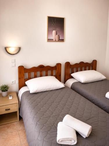 a bedroom with two beds and a nightstand at Crystal Kimolos in Kimolos