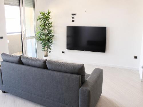 a living room with a couch and a flat screen tv at La Casa al Mare in Pescara