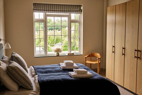 a bedroom with a bed with towels on it at Josty Frederiksberg in Copenhagen