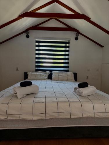 a large bed in a room with a window at Kuća za odmor Nera in Hadžići