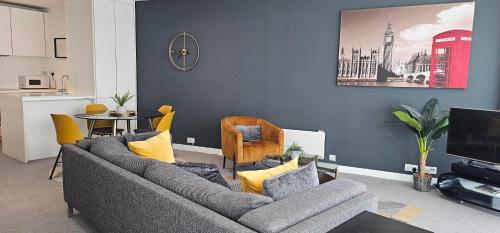 a living room with a couch and a table at Nirbhao in Birmingham