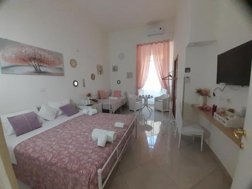 a bedroom with a bed and a living room at Falanga Family Guests Accommodation in Civitavecchia
