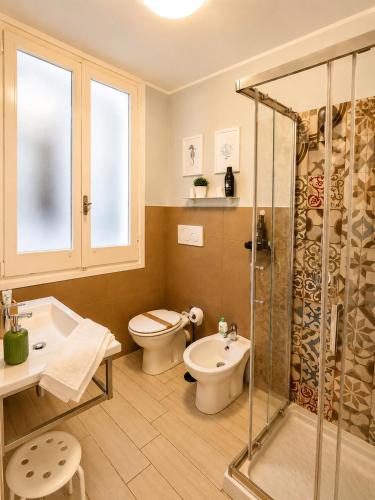 a bathroom with a shower and a toilet and a sink at Torrearsa 17 in Trapani