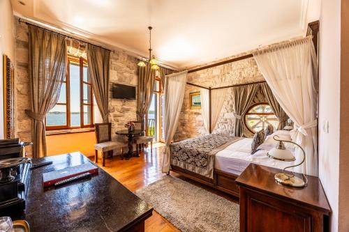 a bedroom with a bed and a desk at Heritage Boutique Hotel Adriatic-Adults only in Orebić