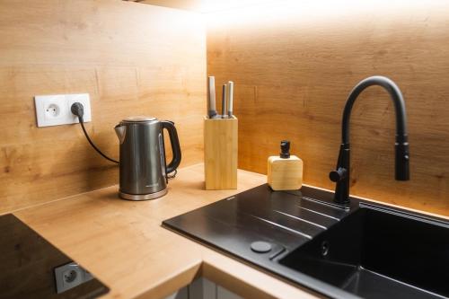a kitchen counter with a sink and aaucet at Apartmány Slanica in Námestovo