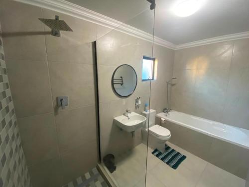 a bathroom with a toilet and a sink and a shower at Springbok Guest Farm in Springbok