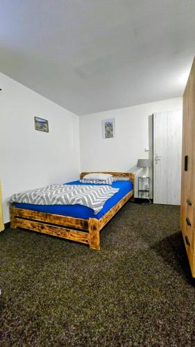a bedroom with a large bed in a room at Ubytko 151 Broumov in Broumov