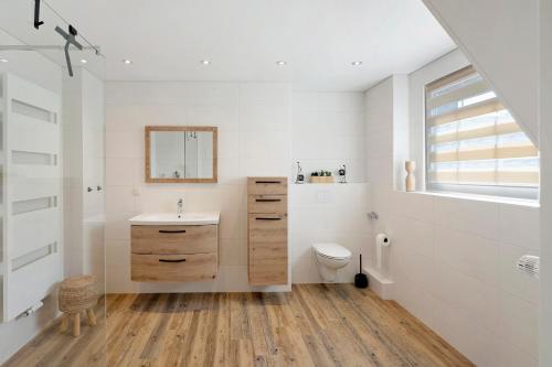 a bathroom with a sink and a toilet at Ferienwohnung "Am Waldrand" in Bottrop