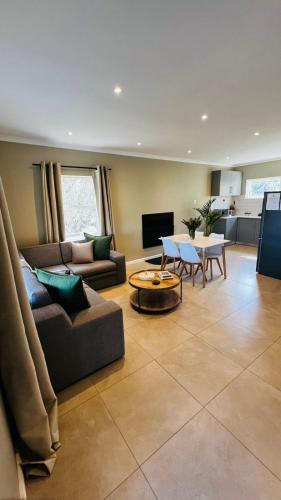 a living room with a couch and a table at Die Kothuis in Wolseley