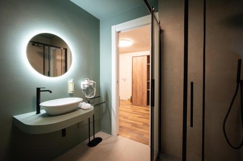 a bathroom with a sink and a mirror at I Segreti del Chiostro - Le Dimore in Palermo