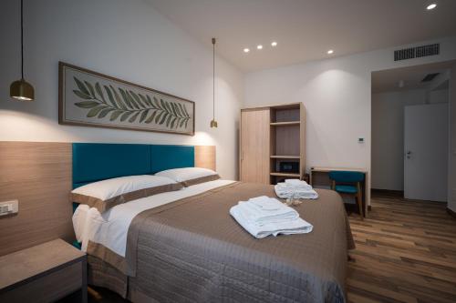 a bedroom with a bed with towels on it at I Segreti del Chiostro - Le Dimore in Palermo