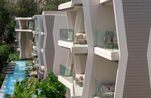an aerial view of an apartment building with a swimming pool at Radisson Blu Resort, Phuket Mai Khao Beach in Mai Khao Beach