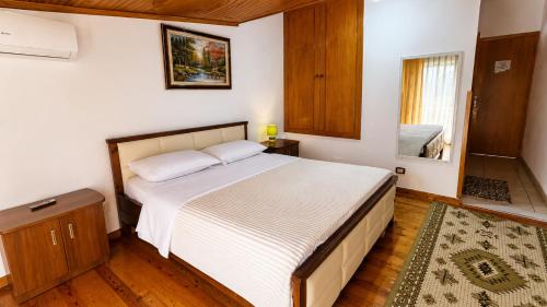 a bedroom with a large bed in a room at Villa Hodo in Vlorë